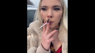 A Glamour Teen is Smoking and Spitting Loogies on the Ground Making Big Spit Puddle
